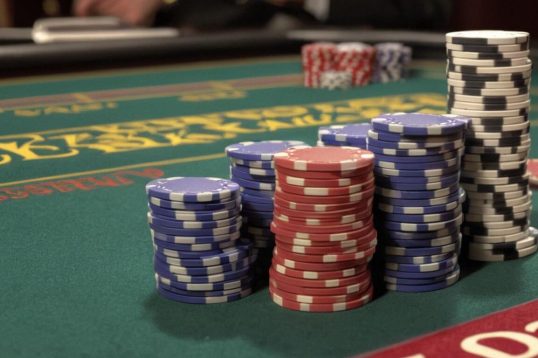 stacks of casino chips on blackjack table