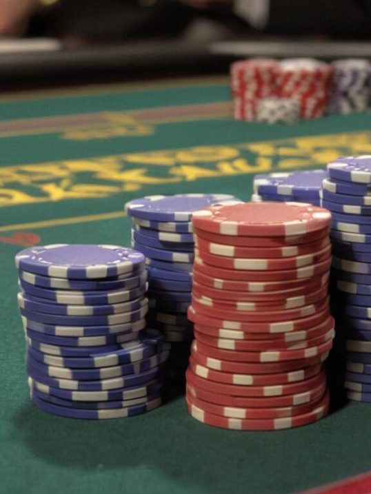 stacks of casino chips on blackjack table